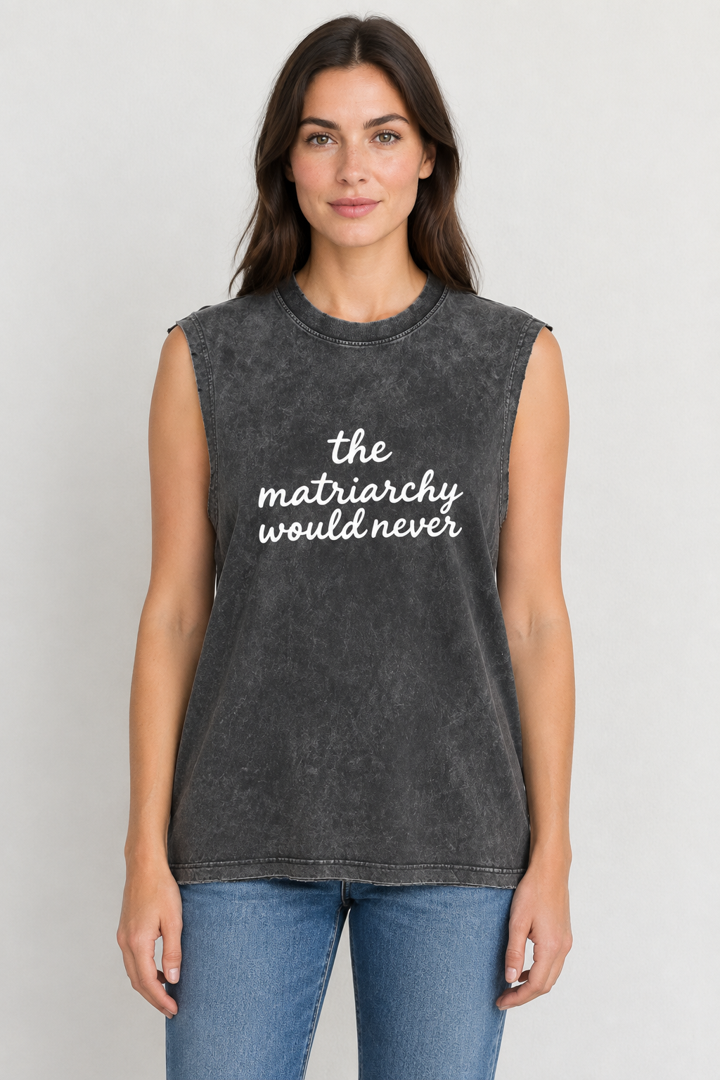 AI-generated mockup of a woman wearing a snow-washed charcoal tank with white The Matriarchy Would Never script and blue jeans.