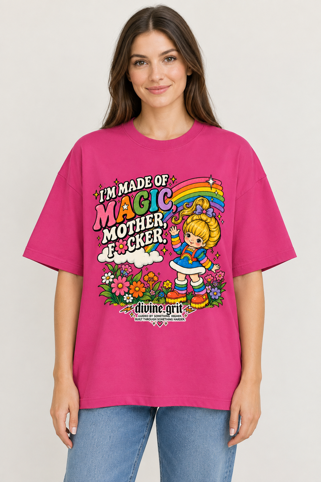 AI-generated mockup of a woman wearing the pink oversized Made of Magic graphic T-shirt with rainbow lettering, cartoon girl and flowers.