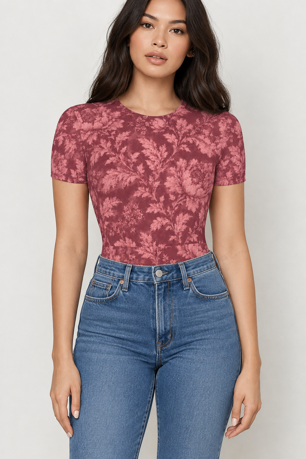 AI-generated mockup of a woman wearing the Bordeaux Bloom burgundy floral short sleeve bodysuit with high-waisted blue jeans.