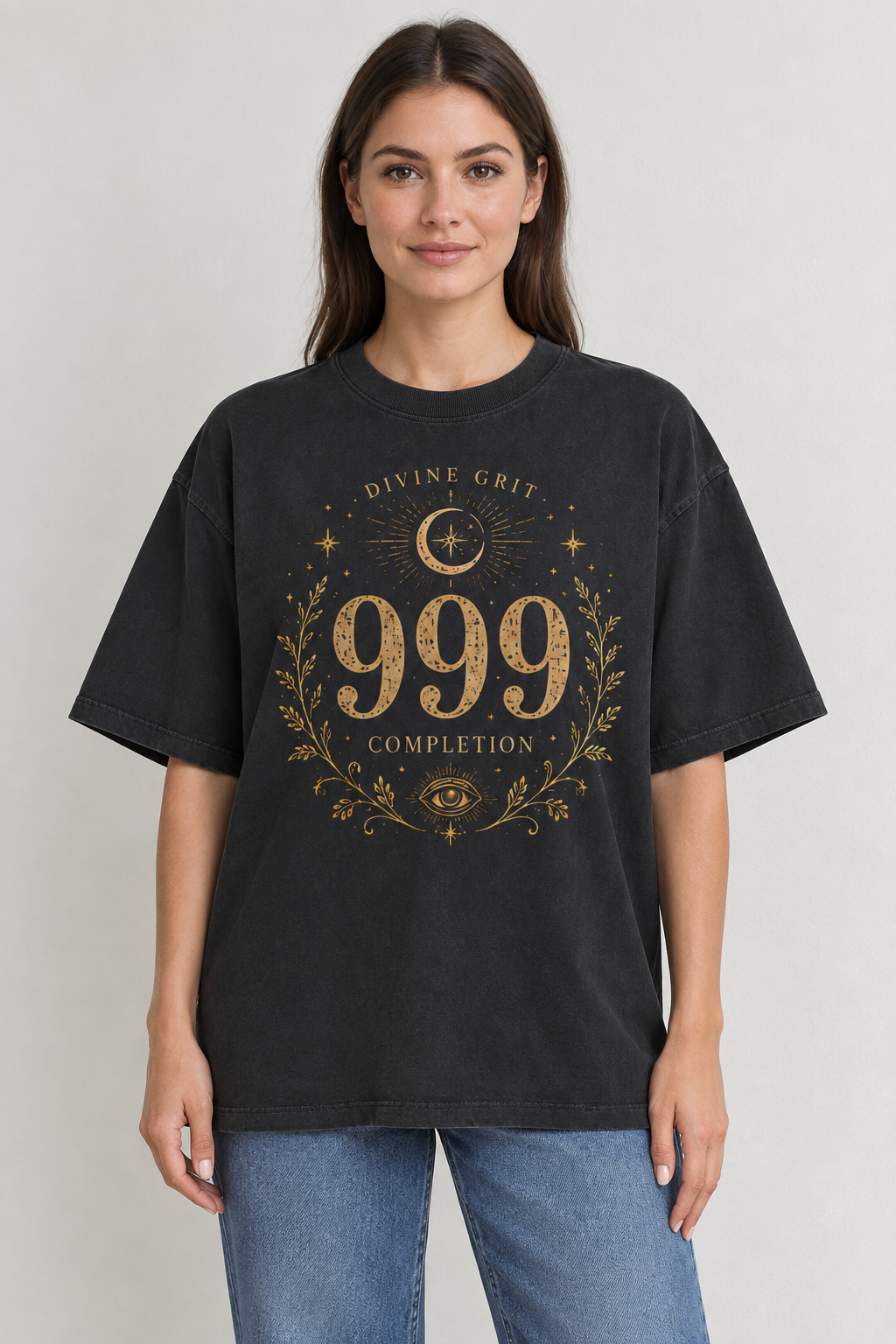 AI-generated mockup of a woman wearing a black oversized 999 Completion T-shirt with gold-toned crescent moon, leafy branches and eye artwork.
