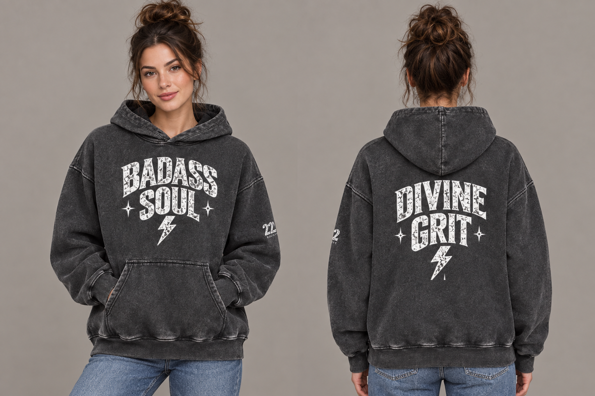 Woman modeling the washed-black oversized Badass Soul hoodie in front and back views, showing white statement lettering, stars and lightning bolts.