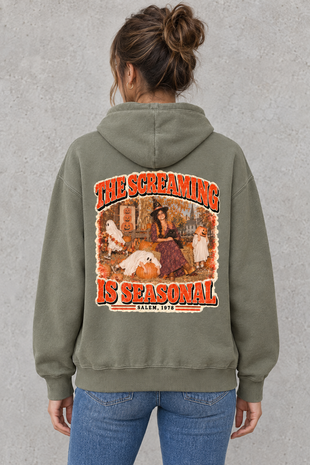 AI-generated mockup of a woman showing The Screaming Is Seasonal back graphic on the Gray Green Halloween hoodie.