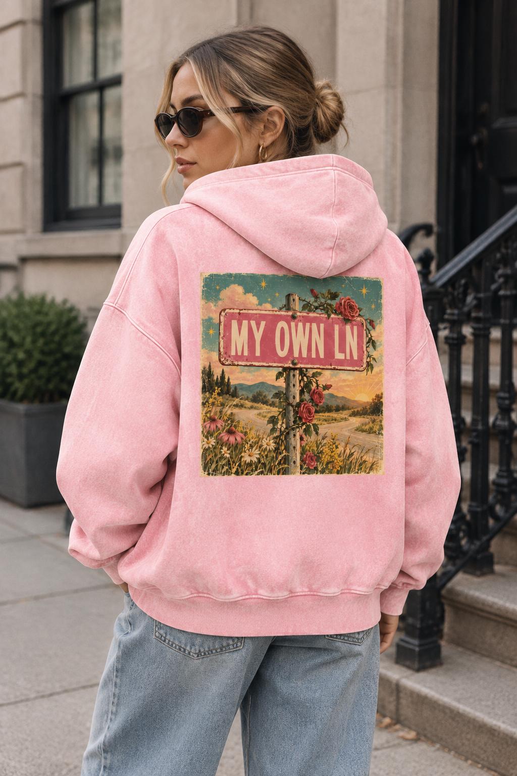 Lifestyle mockup of the pink hoodie